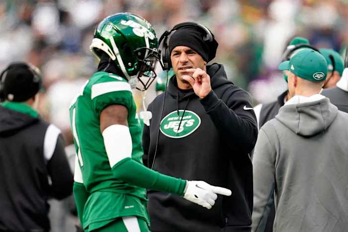 Robert Saleh holds up his hand talking to Sauce Gardner, holding out two fingers to make a small gap